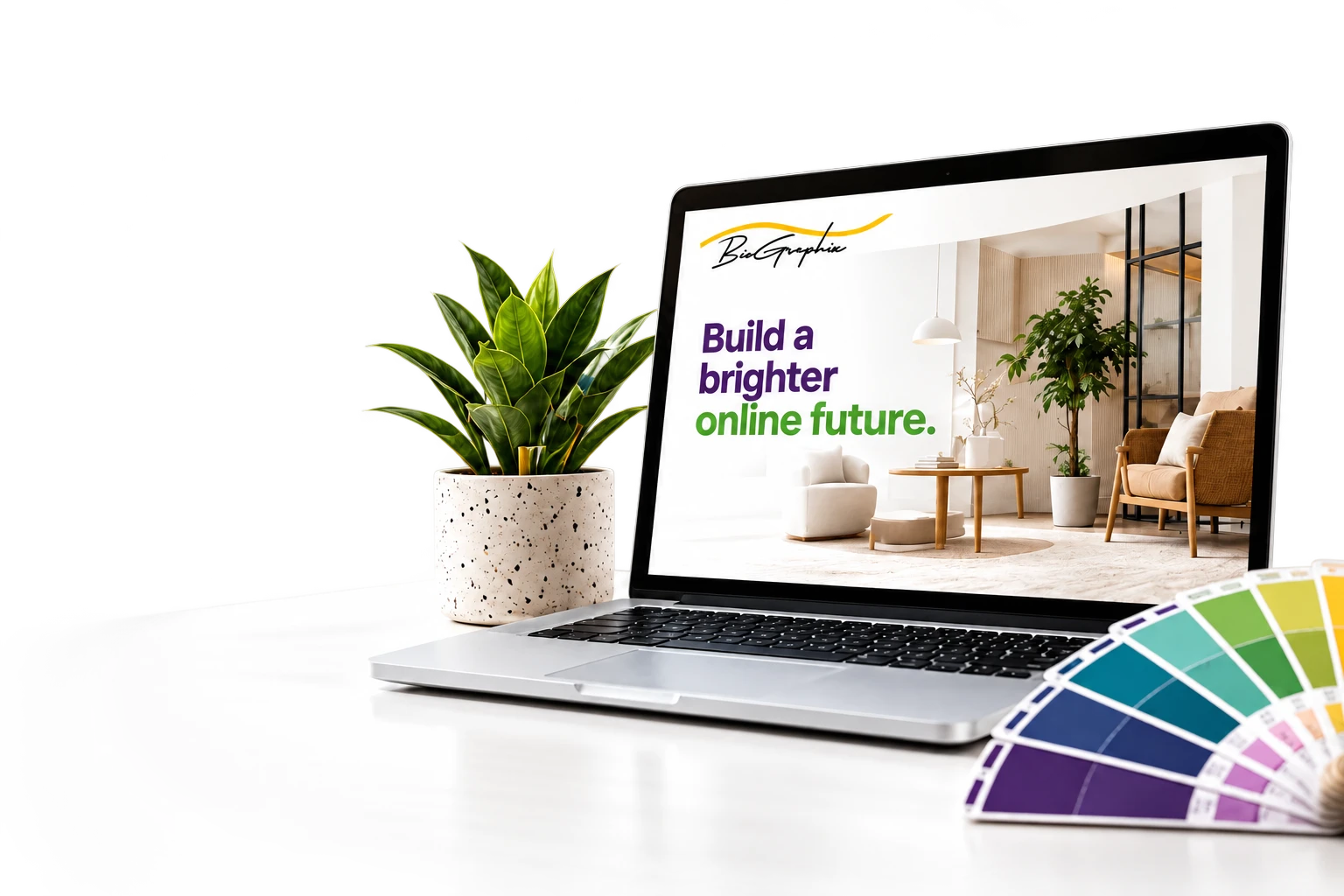 Laptop displaying a Biographix website design with plant and colour samples